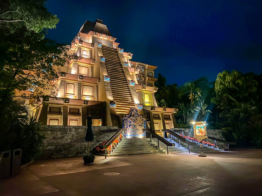 EPCOT’s Mexico Pavilion pyramid at night, stepped temple façade lit against the World Showcase sky